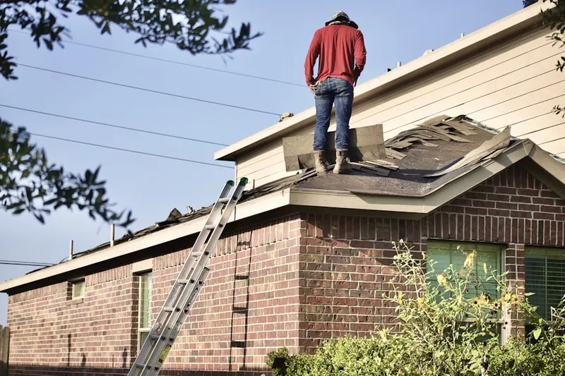 Professional roofer working on a residential roof in New Cassel